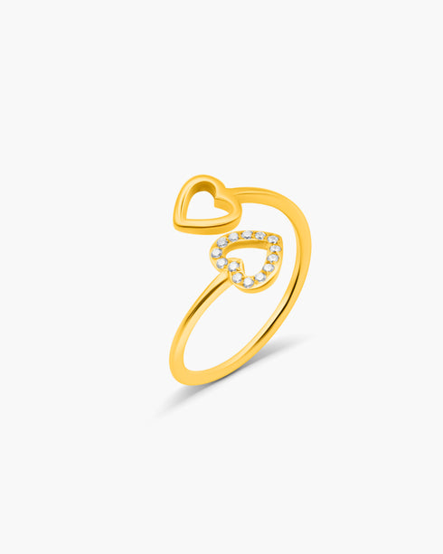 Gold ring with a heart design on a white background